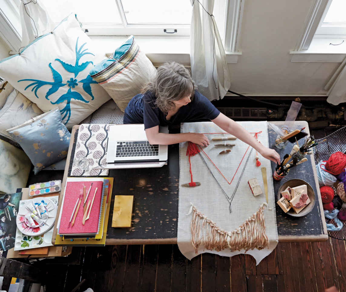PILLOW TALK. The pillows that line this cozy corner nook are all the homeowner’s own creations. The large felted bird in the corner has become a signature design for her store.